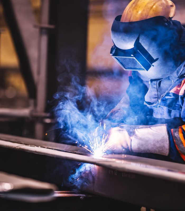 Worker welding in a factory. Heavy industry, welder work